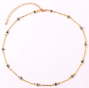 Macro detail of gold-plated chain with blue evil eye charms and adjustable lobster clasp