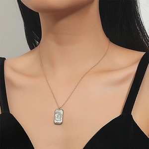 Detail showing a gold-plated tarot lovers pendant necklace with colorful enamel artwork