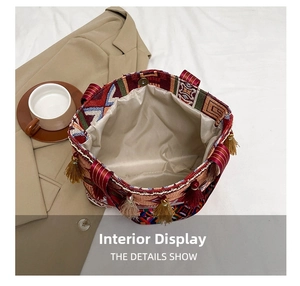 Ethnic style woven tote bag showing spacious interior with colorful tassels and magnetic closure