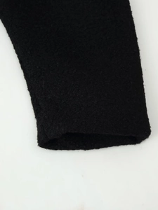 Close-up of the black thickened fleece cuff detail showing textured wool fabric