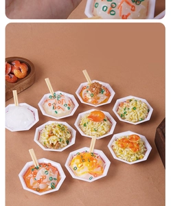 Macro detail of assorted mini food keychains including ramen and fried rice models