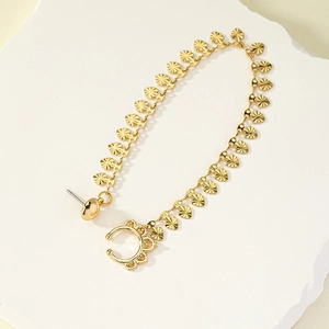 Gold heart link chain earring and ear cuff set on white stone background