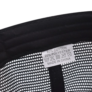Detail view of cotton blend material and washing label on a black baseball cap
