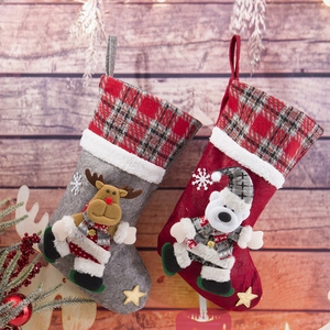 Detailed view of red and grey fabric Christmas stockings with reindeer and polar bear dolls