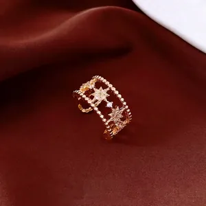 Double-layered gold ring with zircon stars on silk background for a luxury feel