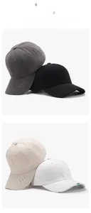 Detail view of distressed cotton baseball caps in grey, black, beige and white colors