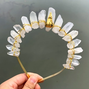 Handmade white crystal crown with gold wire and center skull detail in outdoor light