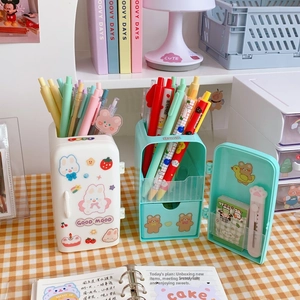 Detail view of refrigerator-shaped pencil holder with mini drawers and cartoon stickers