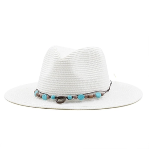 Close-up of white woven straw hat with bohemian beadwork and turquoise stone accents