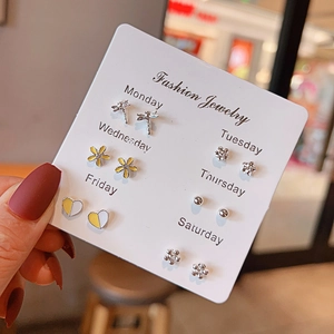 Close-up of 6 pairs minimalist metal stud earrings set with heart and flower shapes
