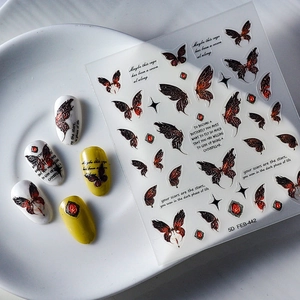 Detailed 5D embossed butterfly nail stickers with ruby elements and motivational text