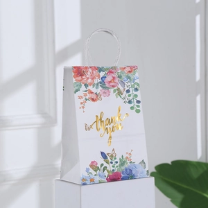White kraft paper gift bag with floral patterns and gold foil Thank You text