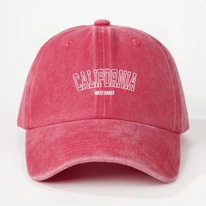 Detailed front view of washed red cotton baseball cap with white CALIFORNIA embroidery