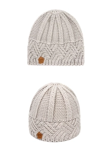 Detail showing thick chunky knit texture and brown leather label on the gray winter beanie