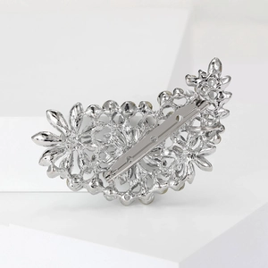 Detailed back view of a silver alloy floral brooch with a sturdy metal safety pin clasp