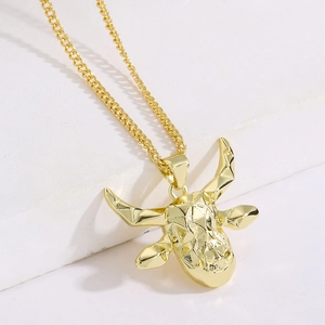 Detailed close-up of 18K gold plated bull head pendant necklace with geometric facets