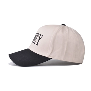 Side view of two-tone cotton baseball cap with black NEY embroidery and stiff brim
