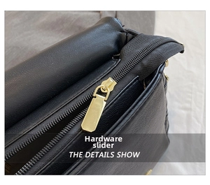 Detail of premium gold-tone metal zipper on black quilted leather crossbody bag