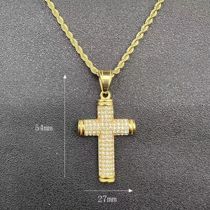 Detail view of gold hip-hop cross pendant with rhinestones and 54mm by 27mm dimensions