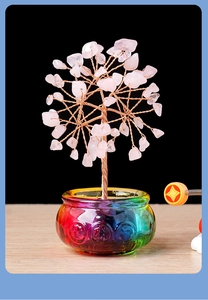 Detail of pink crystal tree with copper branches on a colorful embossed glass bowl
