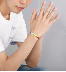 Detailed close-up of rainbow link bracelet with colorful acrylic and steel joints on wrist