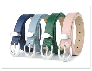 Detail view of colorful PU leather belts with silver oval buckles in four vibrant colors
