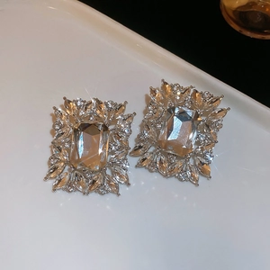 Macro shot of silver crystal earrings with rectangular main stone and marquise accents