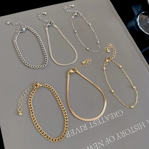 Detail view of 3-piece gold and silver bracelet set with snake and cuban links
