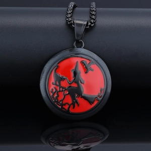 Macro shot of gothic Halloween witch silhouette pendant with black and red glossy finish