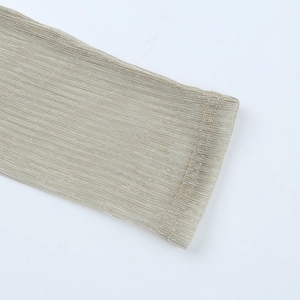 Detail of champagne gold metallic knit sleeve with ribbed texture and double stitching