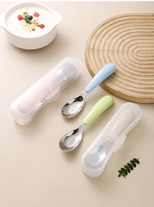 Flat lay of four colorful 316L stainless steel baby spoons with storage cases