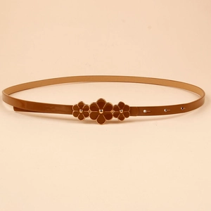 Detail of brown patent leather skinny belt featuring three floral buckles with metal rivets