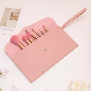 7-piece soft pink makeup brush set with elegant leather envelope storage pouch