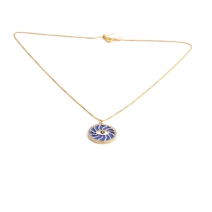 Detail of gold evil eye necklace with blue enamel and sparkling crystal accents