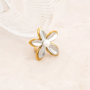 18K gold plated stainless steel flower ring with pearl accent on a textured surface
