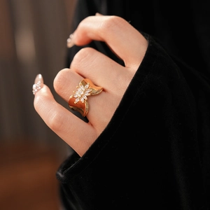 Detail shot of 18K gold plated flower ring with cubic zirconia stones on model finger