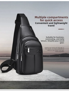 Detail of black pebbled leather chest bag with triple zipper pockets and earphone port
