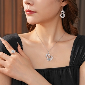 Detailed close-up of zircon and pearl gourd jewelry set including necklace and earrings