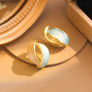French vintage gold earrings with light blue and champagne enamel in macro shot