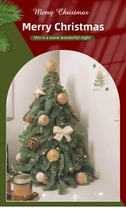 Mini Christmas tree with warm LED lights, gold ornaments, bows, and pine cones