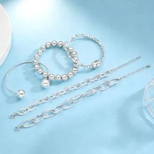 Polished silver alloy bracelet set featuring beaded elastic bands and open cuff styles
