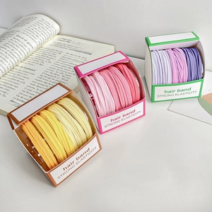 Three boxes of colorful thick elastic hair bands in vibrant gradient candy tones