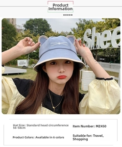 Detail of light blue cotton sun hat featuring cute cat ears and whiskered embroidery
