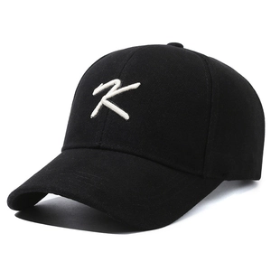 Classic black baseball cap with white K letter 3D embroidery and curved brim design
