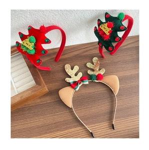 Detail of festive reindeer antlers and Christmas tree headbands with Merry Christmas text