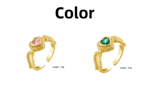 Detail view of gold-plated heart wing rings with pink and green stones weighing 2.8g