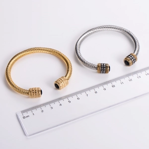 Gold and silver stainless steel cable twist bracelets featuring black onyx stone ends