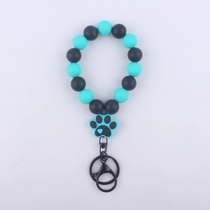 Detail of silicone beaded bracelet keychain with teal paw charm and black metal ring