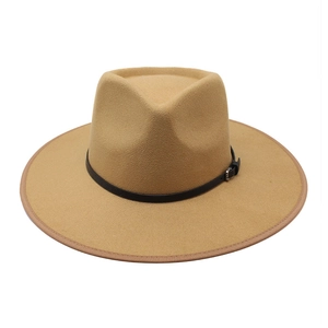 Detail of camel fedora hat with black leather belt, silver buckle and bound edge