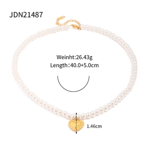 Detailed view of pearl necklace with gold heart pendant and technical dimensions